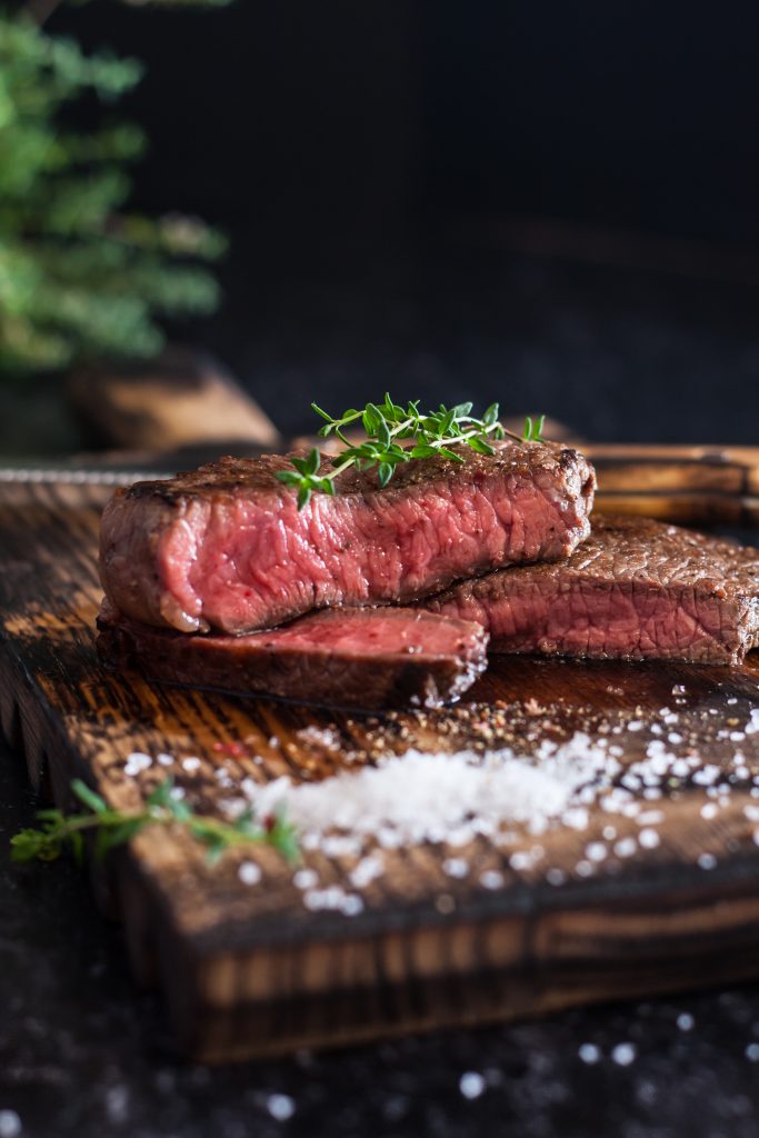 Mediumrare Sliced Beef Steak With Salt Herbs Wooden Board Dark Background 683x1024
